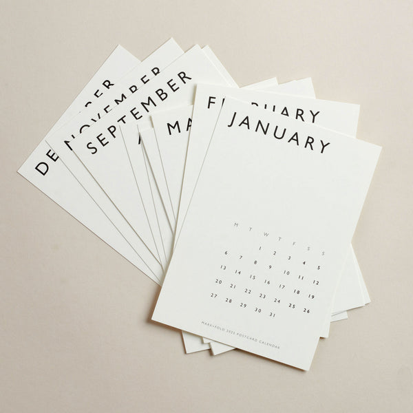 Set of twelve calendar postcards with month names and dates