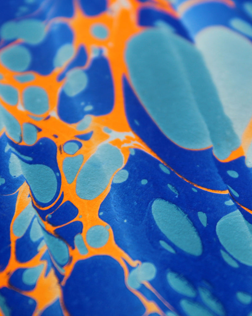 Detail of the Rockpool design by Marmor Paperie for Mark+Fold, using the Spanish Wave technique of traditional paper marbling.