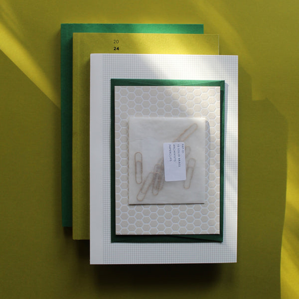 Spring Greens Stationery Set, including Moss Green 2024 Diary, Grass Green layflat ota-bind notebook, Grid pad printed in Scotland, and brass paperclips