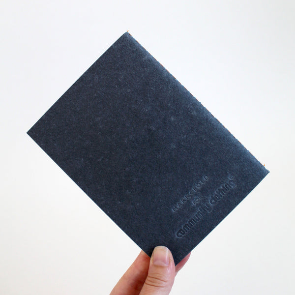 Black A6 notebook with Mark+Fold for Community Clothing logo