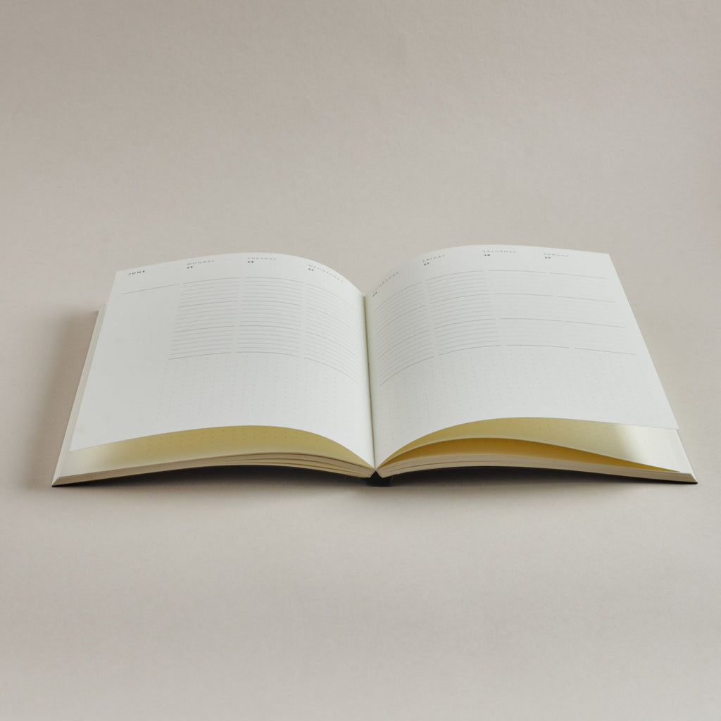 Open 2026 Diary with week-view pages on a plain background, showing layflat thread-sewn binding
