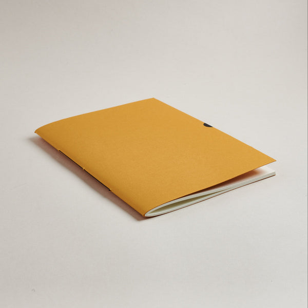 mustard Yellow a5 medium notebook on a light gray background