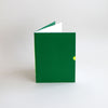 Hand-bound A5 Exercise book in green, with neon foil thumbcut detail