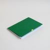 Hand-bound A5 Exercise book with plain pages. Cover in tennis ball neon, with white foil thumbcut detail