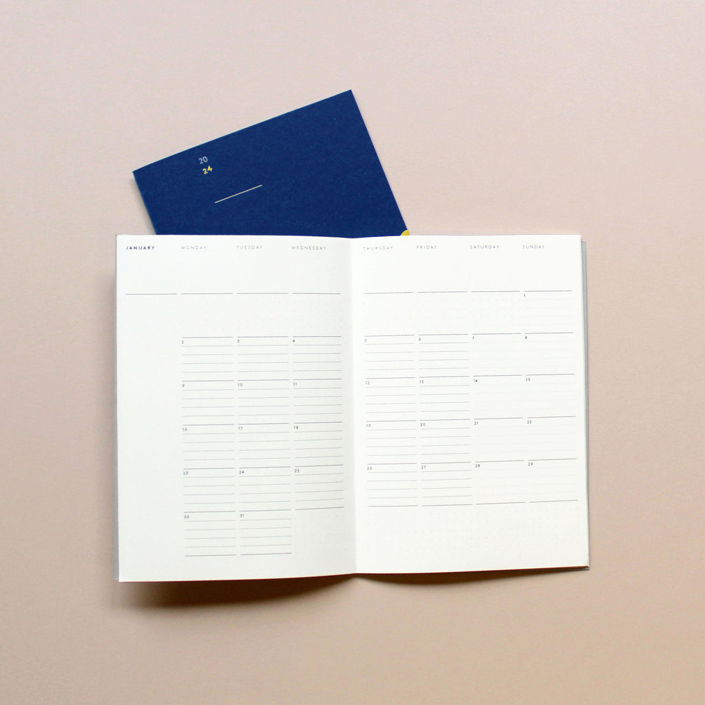 2024 Monthly planner in navy, with a month per double-page layout