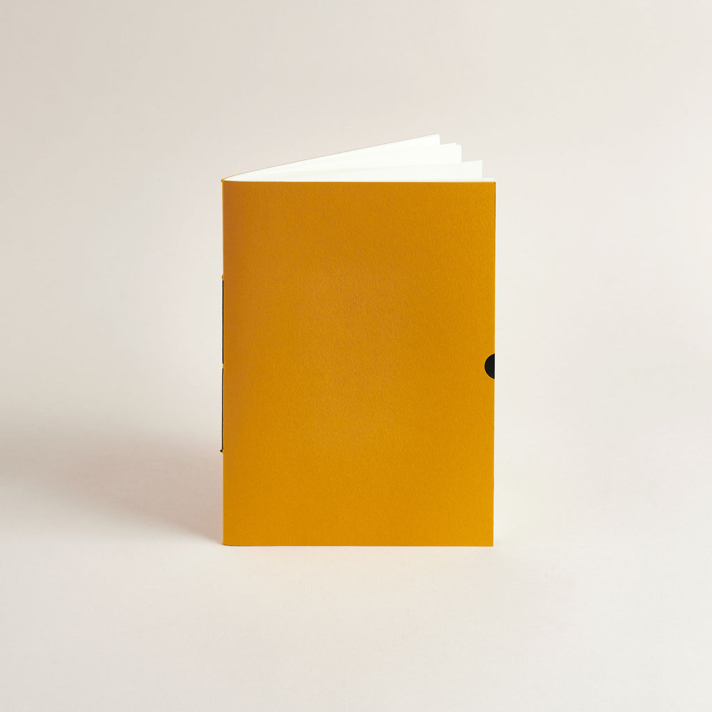 A5 Mustard Exercise Book notebook on a light beige background
