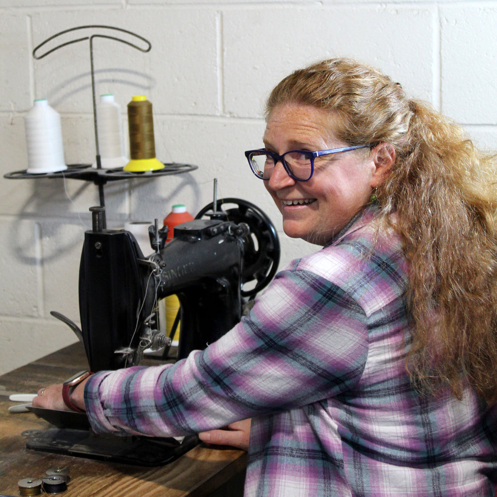 Vicki at the Suffolk bindery, sewing Mark+Fold Exercise Books on a singer sewing machine.