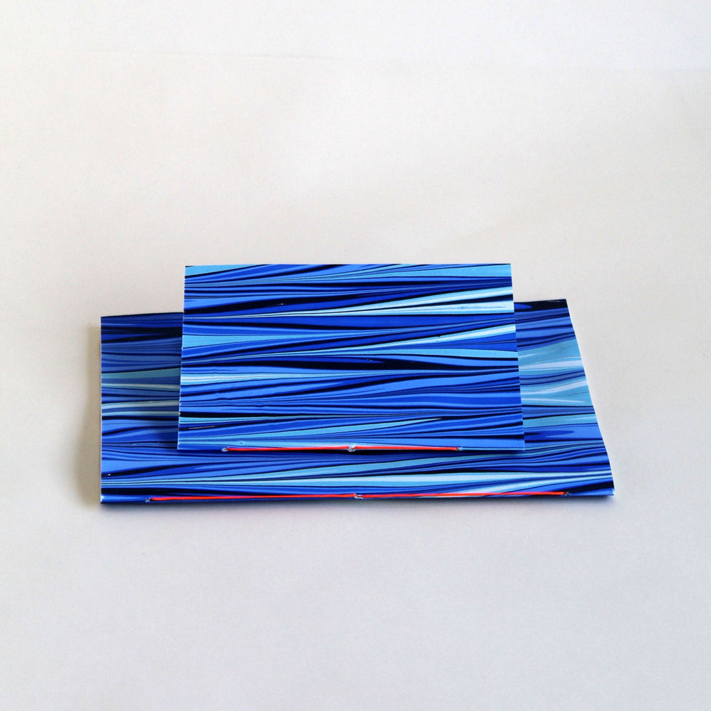 Pair of notebooks in A5 and A6, featuring hand-marbled tide design by Marmor Paperie for Mark+Fold, using ebru turkish marbling technique. Covers made in Deptford London.
