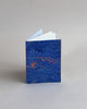 A6 notebook, featuring hand-marbled wave design by Marmor Paperie for Mark+Fold, using the french curl ebru turkish marbling technique