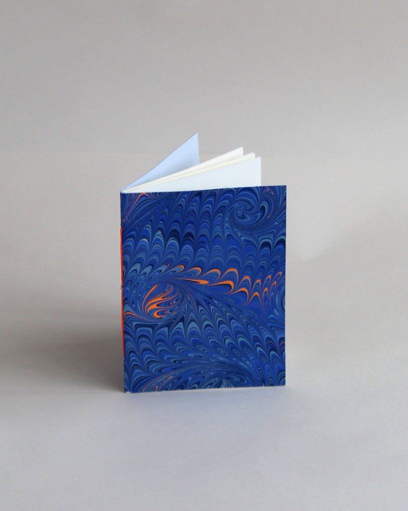 A6 notebook, featuring hand-marbled wave design by Marmor Paperie for Mark+Fold, using the french curl ebru turkish marbling technique