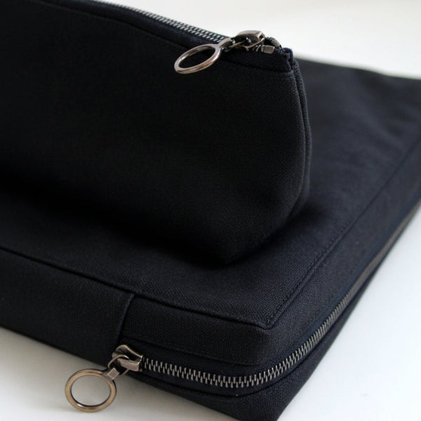 Black canvas pouch with zipper on a white background