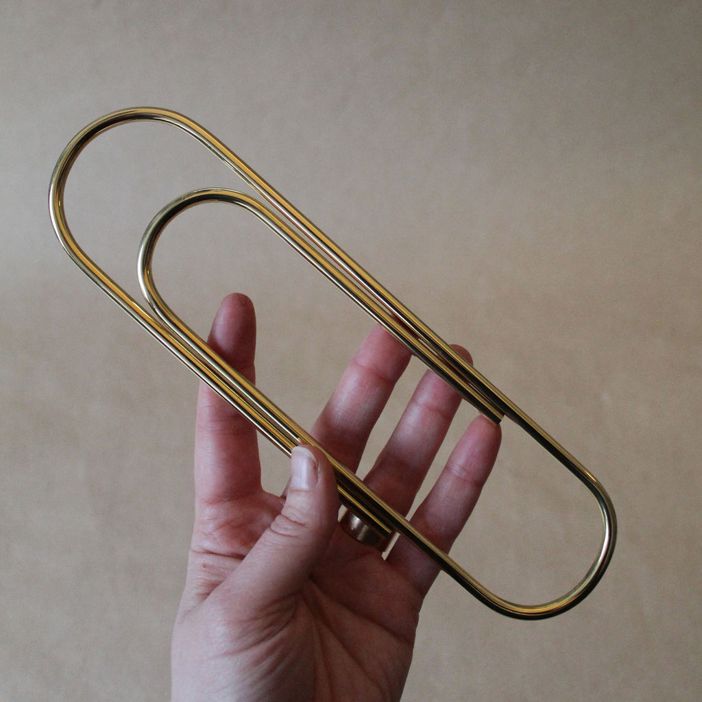 Carl Auböck Paperclip in Solid Brass, for Mark+Fold, luxury desk object, made in Vienna. Hand for scale