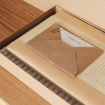 a7 kraft mini envelope with brass paperclip and tissue-wrapped diary by mark+fold