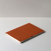 Mark+Fold's Lined notebook in Rust with black details. Layflat ota bind notebook. 120gsm smooth cream paper, suitable for fountain pen, made in Scotland. Sustainable transparenyt production. Modern stationery, designed in London.