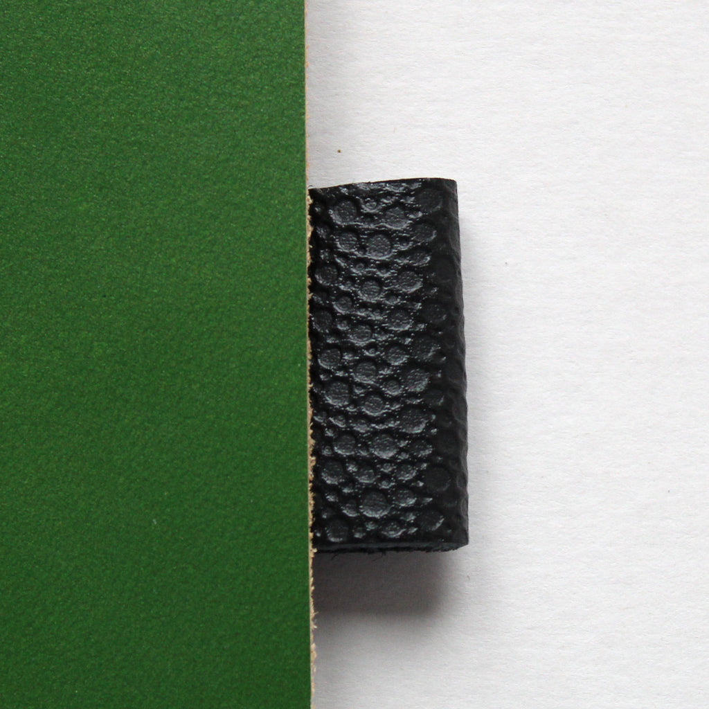 Green leather notebook cover with black pen loop from Doe Leather's archive of rare swatches
