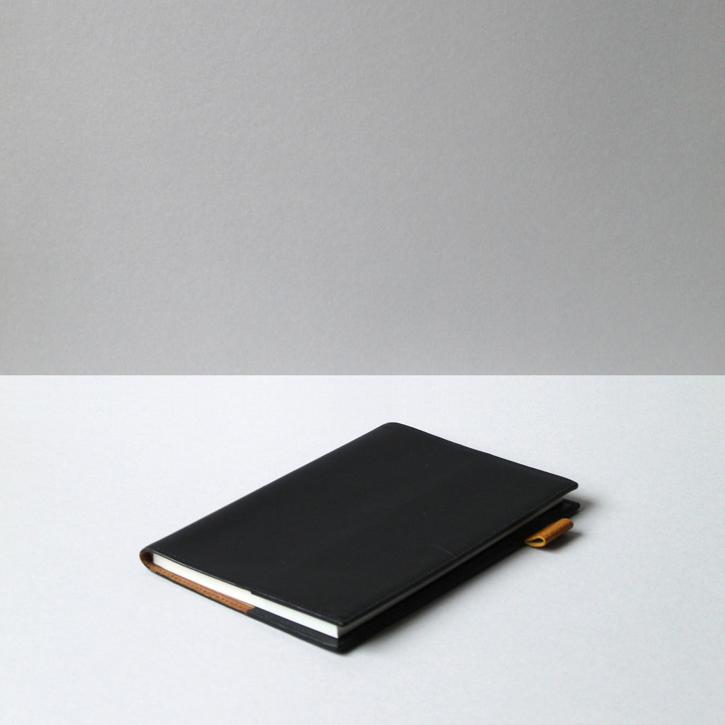 Removable Leather notebook cover  on desk, in black by Doe and Mark+Fold