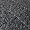 close-up of Piñatex sustainable leather alternative, vegan leather material in black