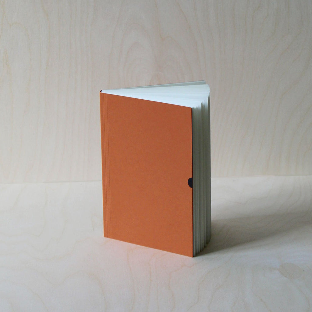 Mark+Fold's Lined notebook in Rust with black foil details. Layflat ota bind notebook. 120gsm smooth cream paper, suitable for fountain pen, made in Scotland. Sustainable transparenyt production. Modern stationery, designed in London.